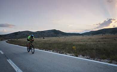 Image showing triathlon athlete riding bike