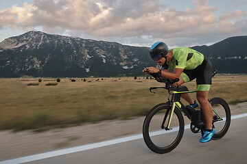 Image showing triathlon athlete riding bike