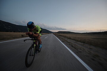 Image showing triathlon athlete riding bike at night