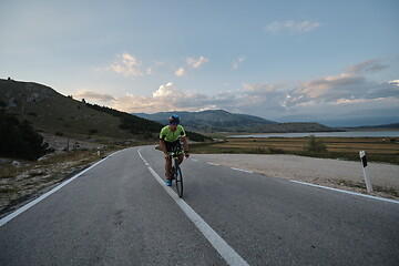 Image showing triathlon athlete riding bike