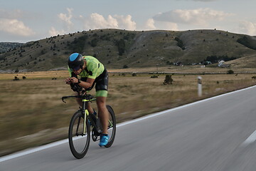 Image showing triathlon athlete riding bike