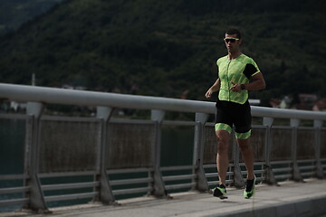 Image showing triathlon athlete running on street