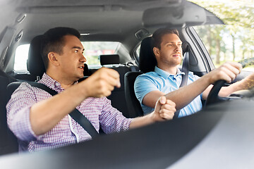 Image showing car driving school instructor teaching male driver