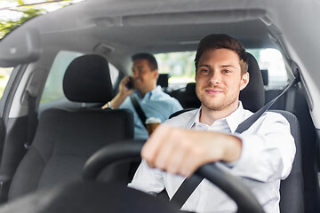 Image showing male driver driving car with passenger