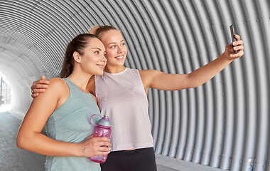 Image showing sporty women taking selfie by smartphone outdoors