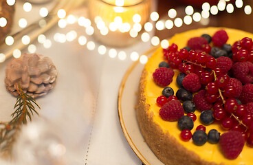 Image showing close up of berry cake on christmas table at home