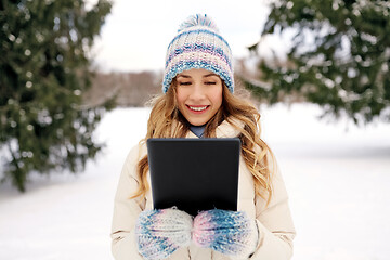 Image showing woman with tablet computer outdoors in winter