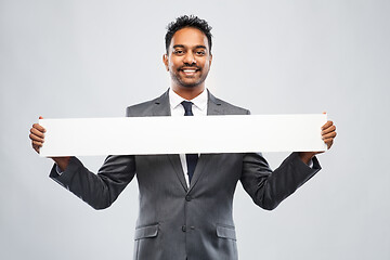 Image showing smiling indian businessman with white banner