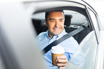 Image showing businessman with takeaway coffee on car back seat