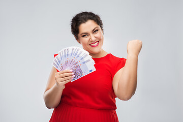 Image showing happy woman holding thousands of money banknotes