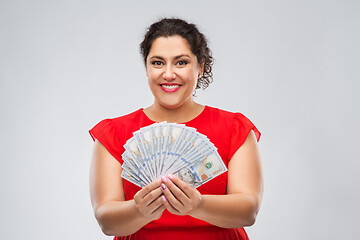 Image showing happy woman holding hundreds of money banknotes