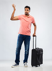 Image showing indian man in polo shirt with travel bag shrugging