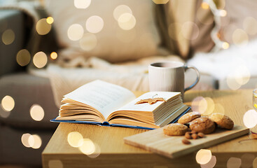 Image showing book with autumn leaf, cookies and tea on table