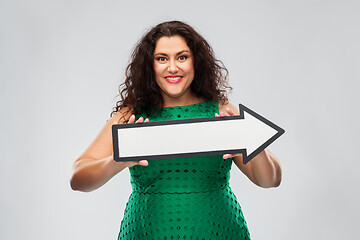 Image showing happy woman in green dress with rightwards arrow