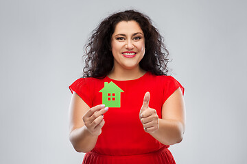 Image showing woman holding green house and showing thumbs up