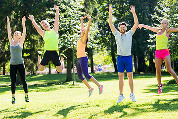 Image showing group of happy friends jumping high at park