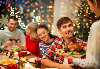 Image showing happy friends having christmas dinner at home