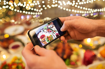 Image showing hands photographing food at christmas dinner