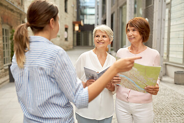 Image showing passerby showing direction to senior women in city