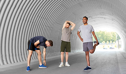 Image showing men or male friends stretching before training