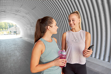 Image showing women or female friends with smartphone and flask