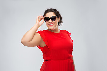 Image showing happy woman in red dress and black sunglasses