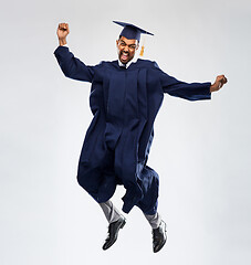 Image showing happy male indian graduate student jumping