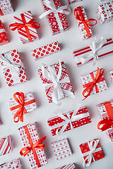 Image showing Various pattern and size Christmas boxes placed on white background. Wrapped in festive paper