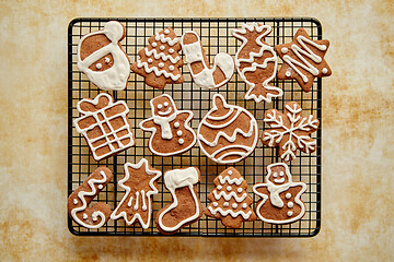 Image showing Fresh baked Christmas shaped gingerbread cookies placed on steel grill