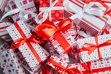 Image showing Christmas concept. Close up on festive paper wrapped gifts with ribbon