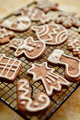 Image showing Fresh baked Christmas shaped gingerbread cookies placed on steel grill