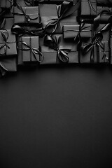 Image showing A pile various size black boxed gifts placed on stack. Christmas