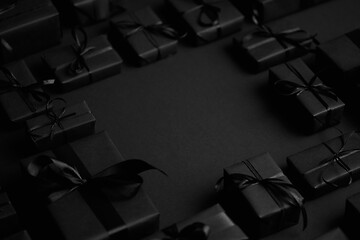 Image showing Arranged Gifts boxes wrapped in black paper with black ribbon on