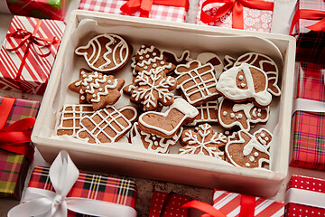 Image showing Delicious fresh Christmas decorated gingerbread cookies placed in wooden crate