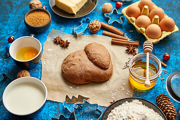 Image showing Gingerbread dough placed among various ingredients. Christmas baking concept