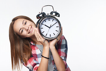 Image showing Portrait of smiling teen girl holding big clock