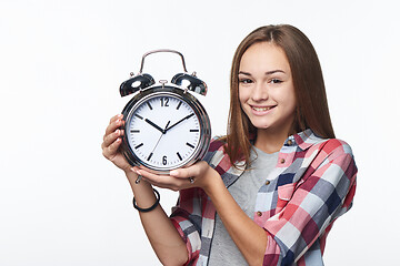 Image showing Portrait of smiling teen girl holding big clock