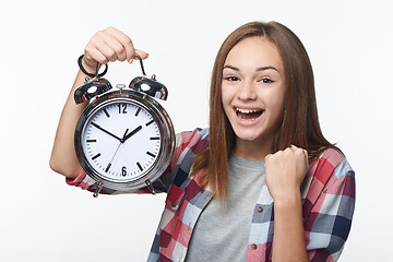 Image showing Portrait of smiling teen girl holding big clock