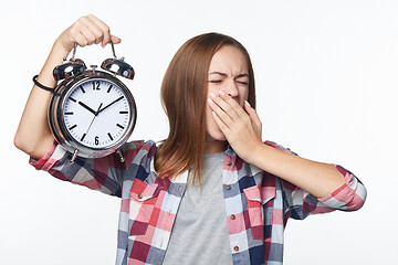 Image showing Portrait of smiling teen girl holding big clock