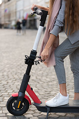 Image showing User unlocking rental electric scooter. Eco friendly green modern urban mobility concept of sharing transportation with electric scooters for rent in Ljubljana, Slovenia