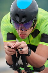 Image showing triathlon athlete riding a bike on morning training