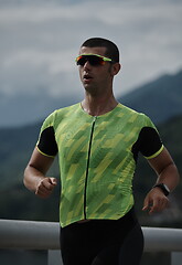 Image showing triathlon athlete running on street