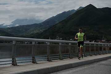 Image showing triathlon athlete running on street