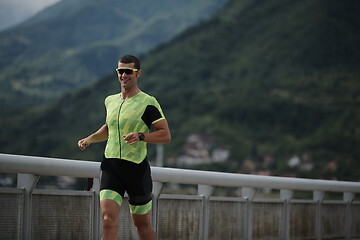 Image showing triathlon athlete running on street