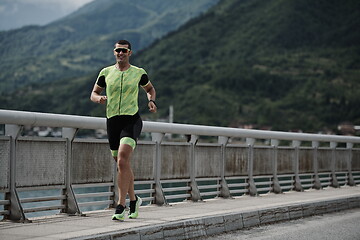 Image showing triathlon athlete running on street