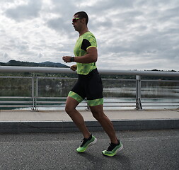 Image showing triathlon athlete running on street