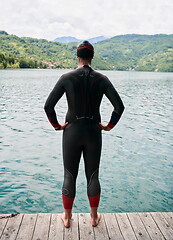 Image showing triathlete swimmer portrait wearing wetsuit on training