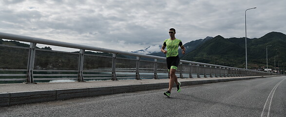 Image showing triathlon athlete running on street