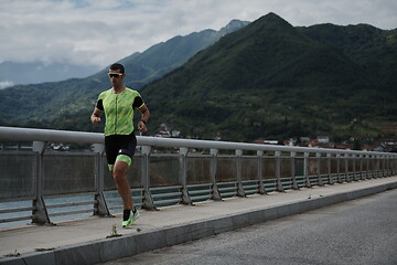 Image showing triathlon athlete running on street