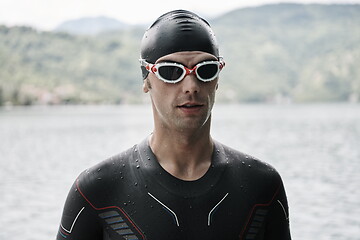 Image showing triathlete swimmer portrait wearing wetsuit on training